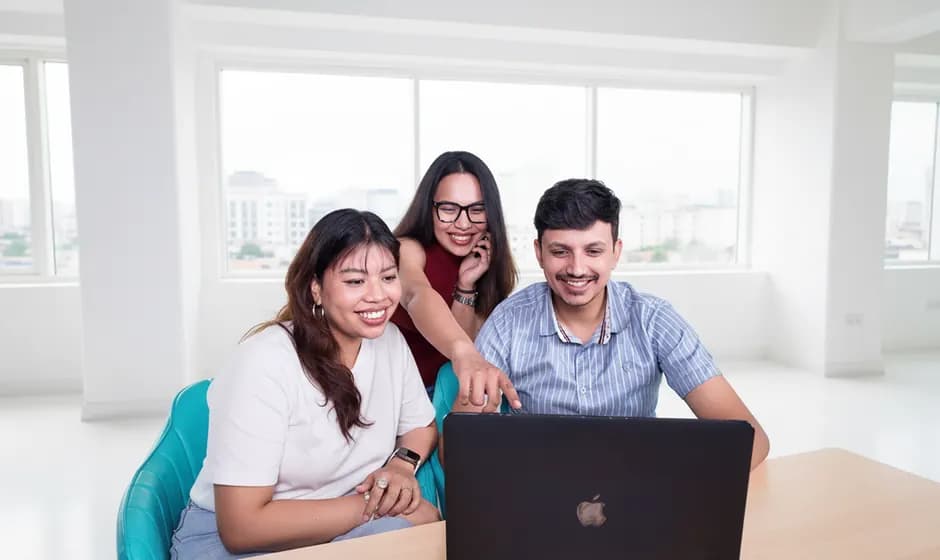 Three Expert Education students reviewing an application together