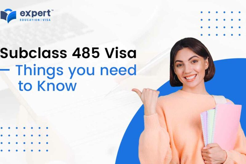 Smiling young student holding books and pointing to the 485 visa 